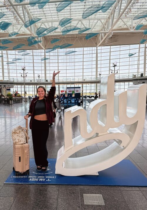 midwest girl standing at Indianapolis International Airport